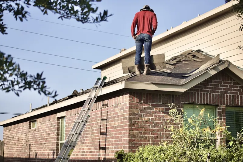 Professional roofer working on a residential roof in Broad Run Farms